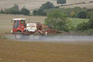 Self Propelled crop sprayer working on a drilled field Pre-emergence.